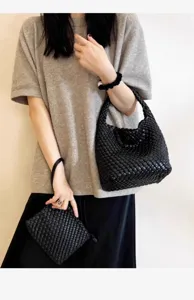 Detailed view of women's black woven leather hobo shoulder bag with matching pouch set stylish