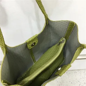 Green woven leather tote bag interior detail, large capacity shoulder handbag for women.