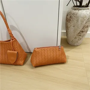 Orange woven leather shoulder bag and pouch set, chic French style baguette bag.