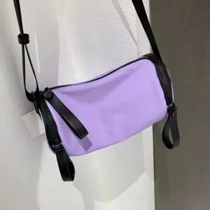 Purple nylon barrel shoulder bag detail, casual crossbody purse with black strap and zipper.