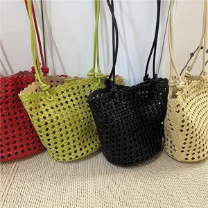 Detailed shot of multi-color woven bucket bags featuring soft leather and chic cutout design.
