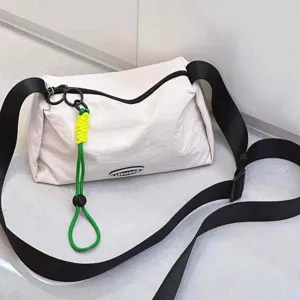 Casual nylon crossbody bag for women, stylish lightweight single shoulder bag with green charm.