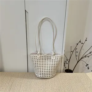 Summer fashion hollow woven leather bucket bag casual tote handbag with top handles.