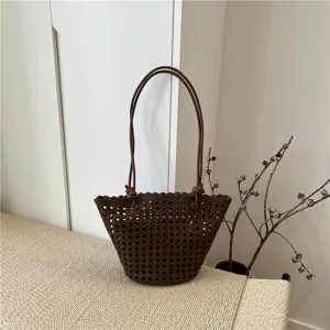 Stylish dark brown woven leather shoulder bag, trendy hollow bucket bag for women daily use.