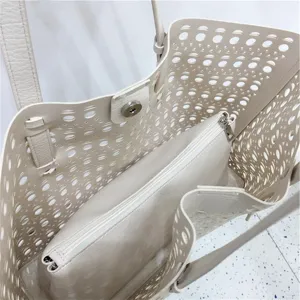 Detail view of beige hollow-out tote bag interior structure, showing spacious storage capacity.