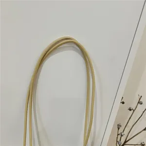 Detail view of the soft leather handle for summer fashion woven bucket tote bag.