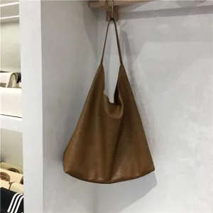 Soft leather slouchy brown shoulder tote bag detail showcasing large capacity and minimalist everyday style.