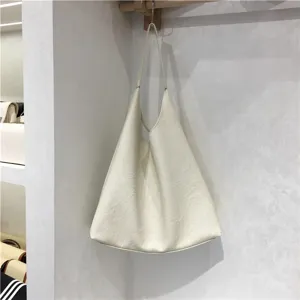 Detail view of the soft leather slouchy tote bag, showcasing texture and elegant minimalist style.