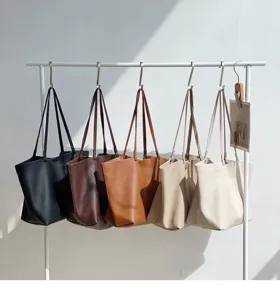 Minimalist leather tote bag hanging display detail showcasing various versatile daily color options.