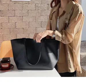 Minimalist black leather tote bag, soft casual shoulder bag for daily use, spacious and stylish.
