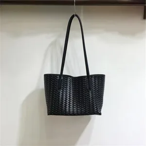 Black woven leather tote bag detail, soft underarm shoulder bag showcasing fine craftsmanship.