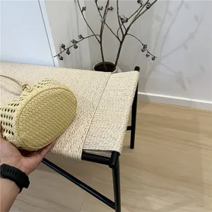 Yellow woven leather bucket bag detail view, showing exquisite craftsmanship and texture.