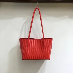 Red woven leather shoulder tote bag, stylish woven design underarm bag, casual basket handbag detail.