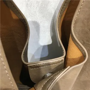Detailed view of the textured soft leather tote bag interior structure and hardware clasp.