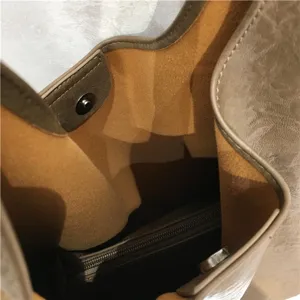 Soft leather tote bag interior detail showing spacious lining and zippered pocket.
