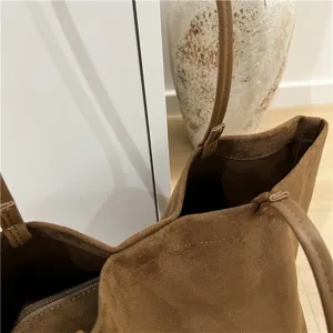 Brown faux suede tote bag detail view, soft texture, thin straps, spacious open interior.