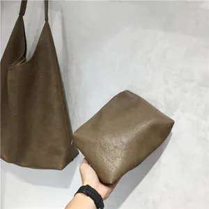 Soft leather slouchy tote bag detail view, casual brown shoulder bag and matching pouch.