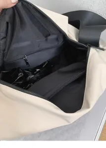 Detailed view of the large capacity canvas tote bag interior, showing zipper pockets.