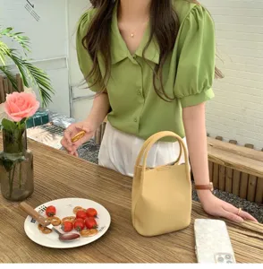 Detail shot of a soft trendy Korean style yellow bucket handbag, ideal for everyday casual wear.