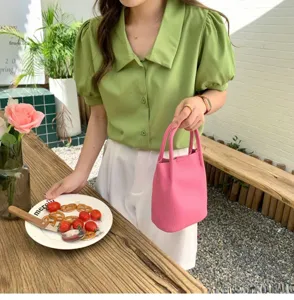 Stylish pink leather bucket bag for women, trendy chic handbag with top handle and casual design.