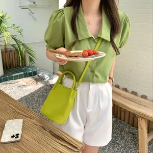 Stylish green leather bucket bag for women, soft textured crossbody shoulder bag everyday use.