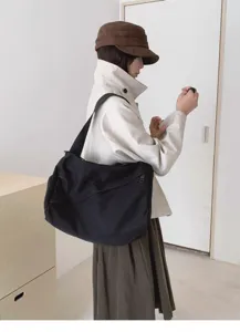 Minimalist black canvas crossbody bag, large capacity casual shoulder bag for daily use.