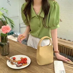 Chic minimalist yellow leather bucket bag, stylish top-handle handbag for daily wear.