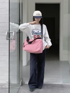 Detailed shot of the stylish pink canvas shoulder bag showcasing large capacity and durable strap.