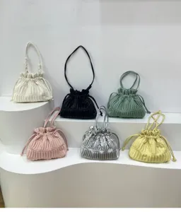 Detailed view of trendy pleated drawstring shoulder bags showcasing multiple vibrant colors.