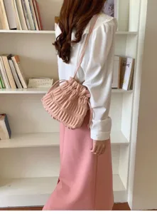 Pink pleated drawstring shoulder bag detail view, sweet style crossbody accessory.