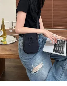Minimalist black nylon crossbody bag, portable casual shoulder bag with drawstring design.