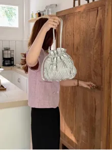 Silver metallic ruched drawstring shoulder bag, trendy casual crossbody handbag for women.