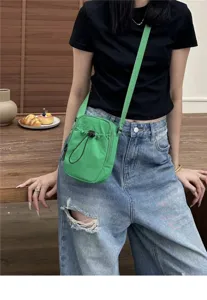Casual nylon crossbody phone bag in vibrant green color, featuring convenient drawstring pocket.