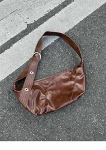 Brown oil-wax leather shoulder bag, vintage dumpling bag with wide strap and metal eyelets.