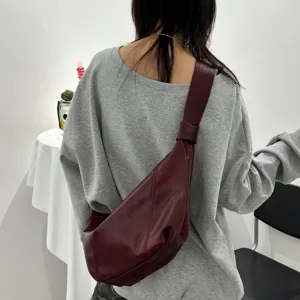 Dark red soft leather crossbody bag, stylish wide strap dumpling bag for daily commute.