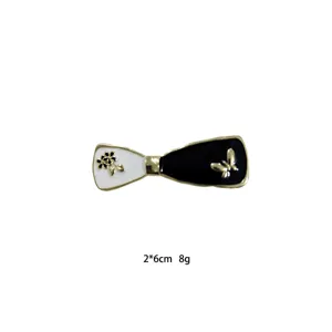 Black and white bow hair clip detail showing exquisite enamel texture and metal edge.