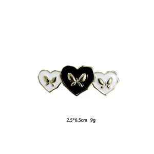 Exquisite black and white heart hair clip with gold butterfly detail for stylish daily wear.