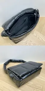 Close-up of black quilted puffer shoulder bag interior pocket and fluffy handle details.