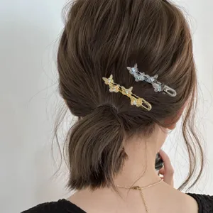 Close-up detail of elegant rhinestone butterfly hair clips for stylish women styling.