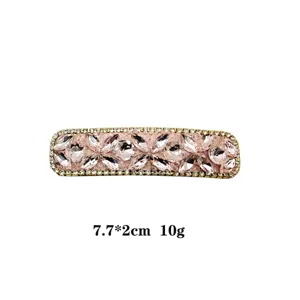 Detail view of the elegant rhinestone hair clip, featuring sparkling pink crystals and compact size.