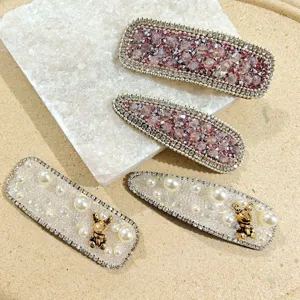 Elegant rhinestone and pearl hair clips set featuring sweet bear charms for women styling.