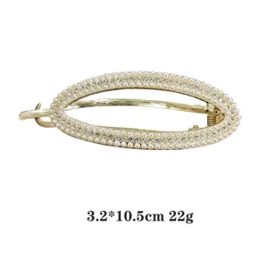 Detailansicht einer eleganten goldenen Legierungs-Haarspange mit Perlen und Strass.