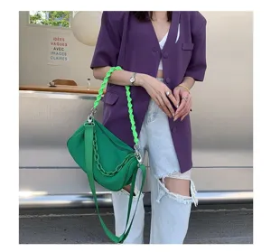 Green canvas underarm shoulder bag detail display in modern fashion daily styling outfit scene.
