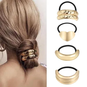 Gold metal hair tie set, geometric ponytail holder, minimalist hair cuff detail shot.