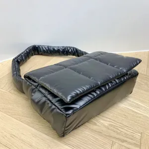 Black padded shoulder bag for women, quilted puffy underarm handbag, casual winter fashion daily use.