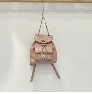 Pink quilted leather backpack with chic chain straps and stylish lock for daily wear.