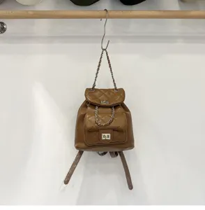 Brown quilted leather backpack with chain straps and metal twist lock for daily women fashion.