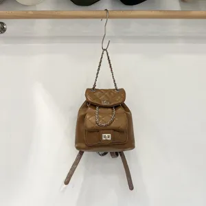 Brown quilted chain backpack, stylish faux leather mini daypack with turn-lock closure.