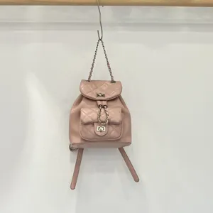 Pink quilted leather backpack with chain straps and chic turn-lock closure for daily casual wear.