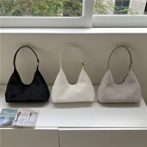 Detail view of fluffy plush hobo shoulder bags in three colors displayed neatly on shelf.